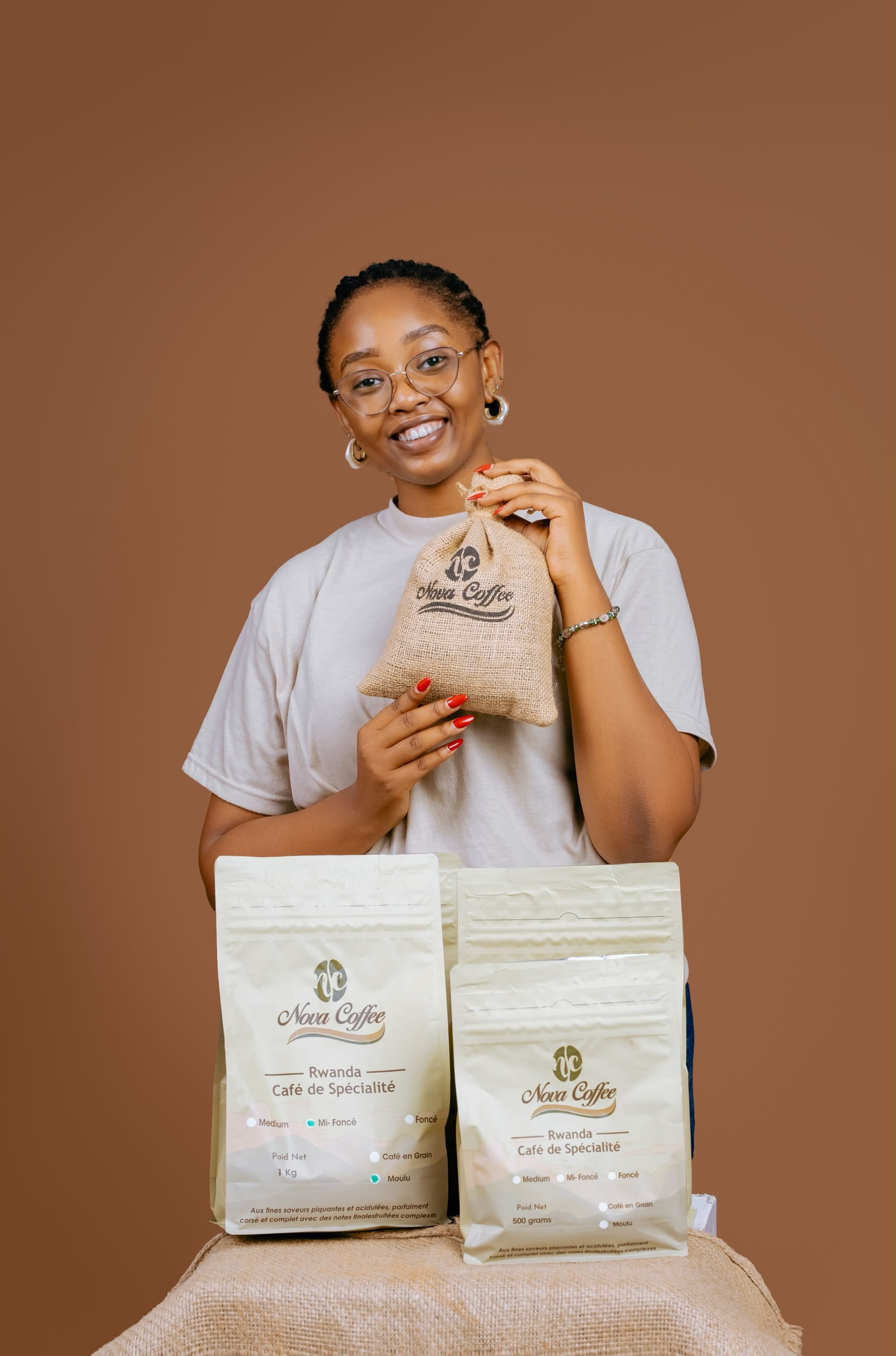 Rwandan woman holding Nova Coffee packaging
